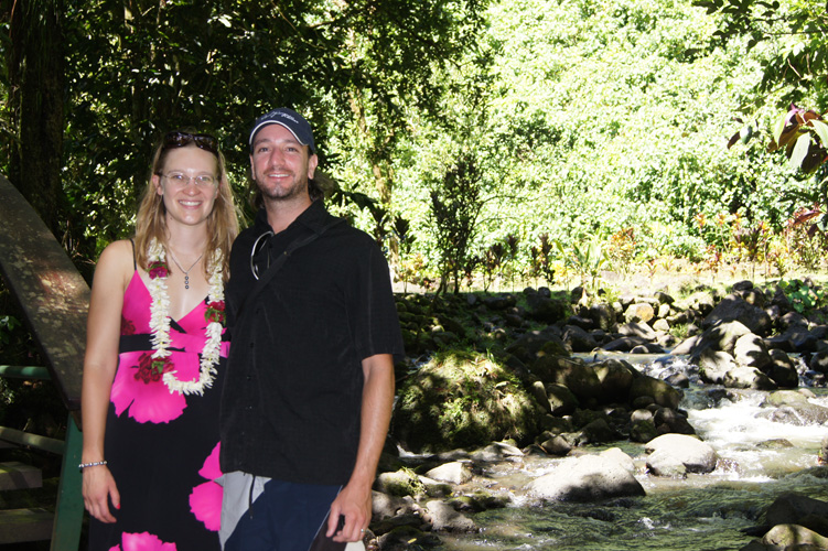 On a bridge over a creek near the waterfall.